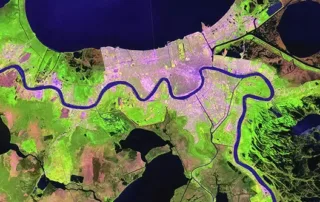 Aerial view of a river in green, captured in a satellite image, illustrating its course through the terrain.