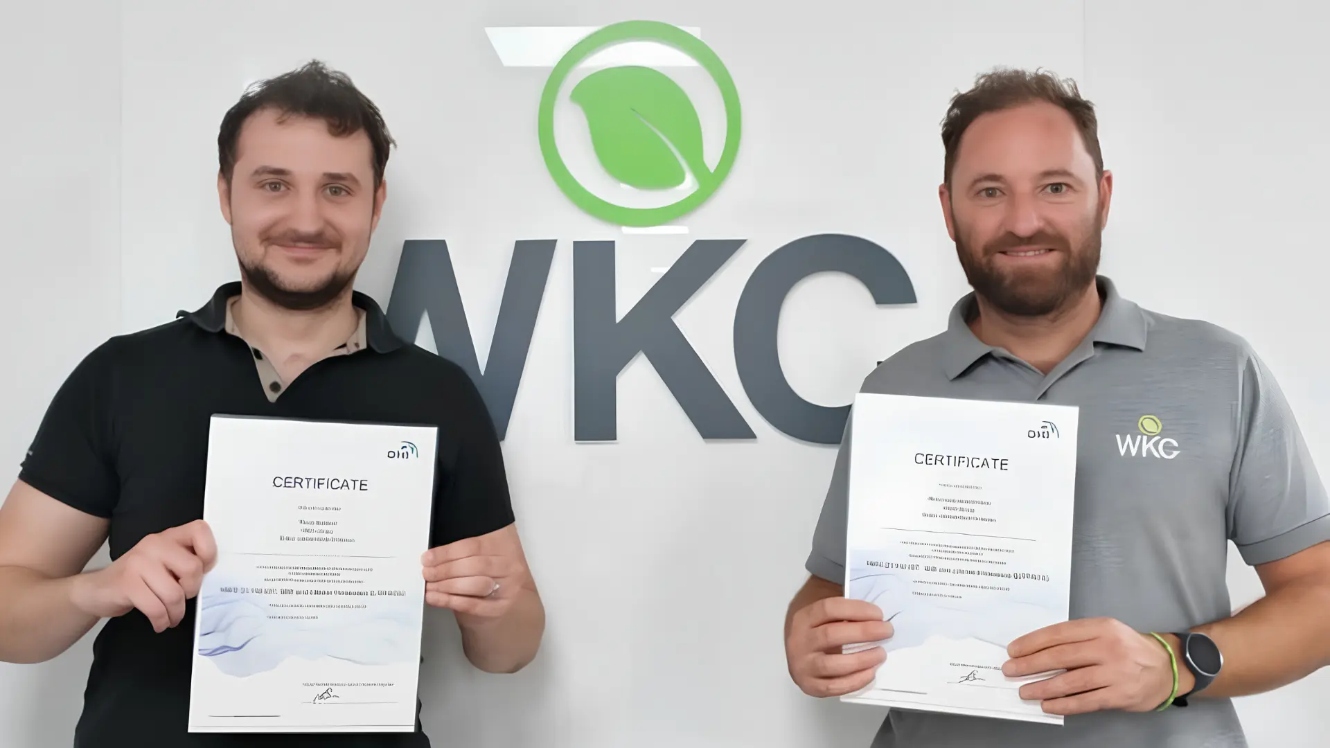 Ravel-Barnard-Bruno-Goncalo-Da-Silva-Hydrodynamic-Modelling-Training-WKC-Group Two men stand with certificates, smiling in front of the WKC logo, marking a significant accomplishment.